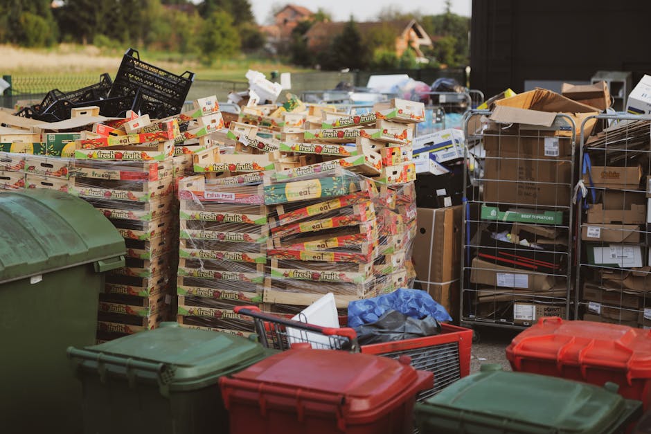 A close-up image of several large black rubbish bags made from thick plastic material, tightly knotted at the tops. The bags are positioned in the foreground, with some appearing slightly crumpled and